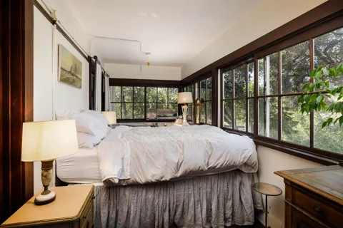 a bedroom with a bed and large window