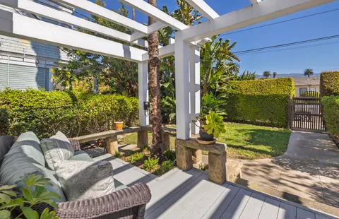 a view of a porch with furniture and a yard