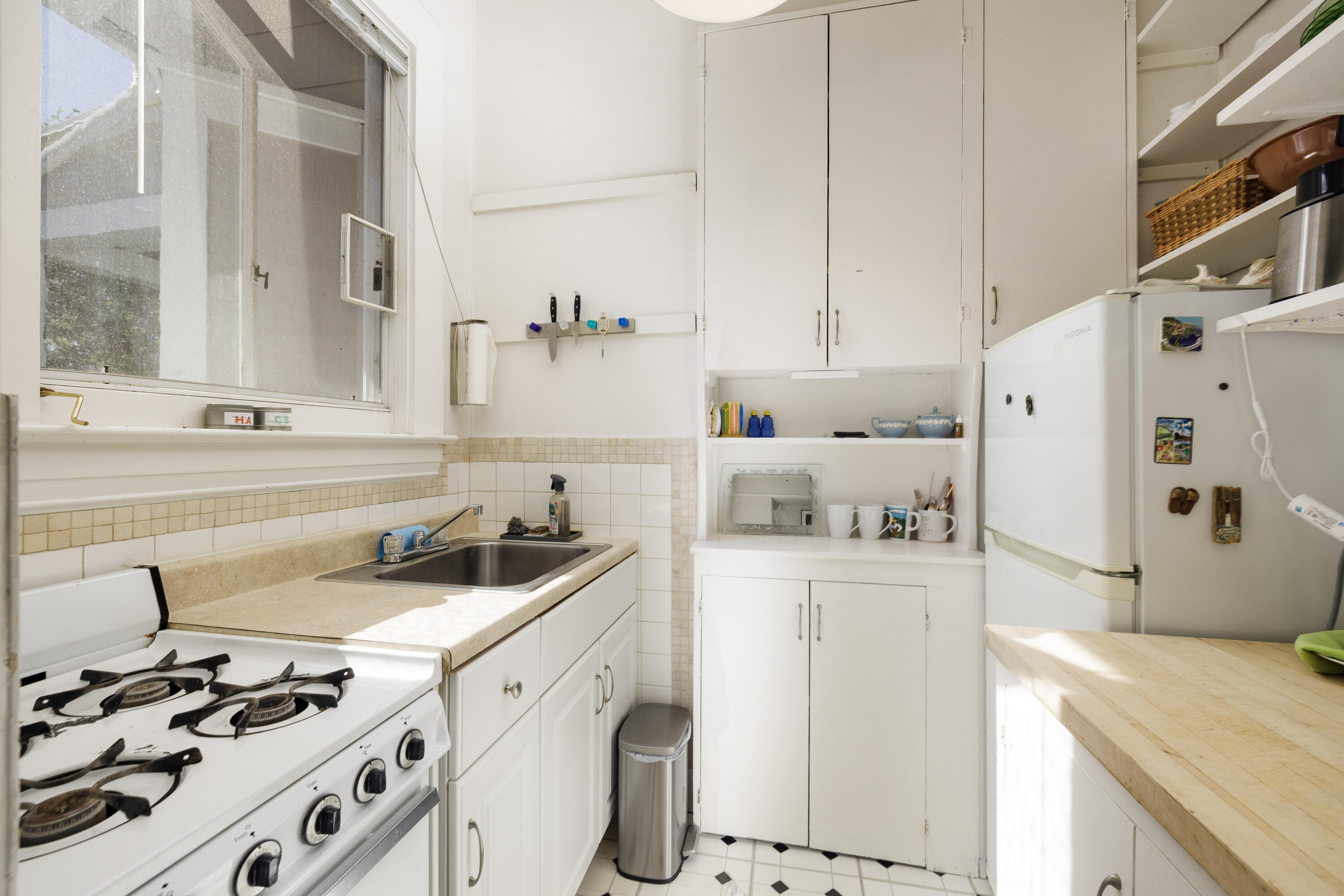 1403 Bath Street Santa Barbara, CA 93101 - Photo 8 of 24 a kitchen with kitchen island a sink stove and refrigerator