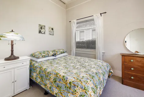 a bedroom with a bed and a dresser