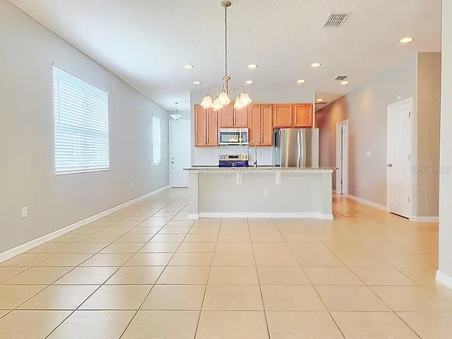 a view of a kitchen with furniture and large windows