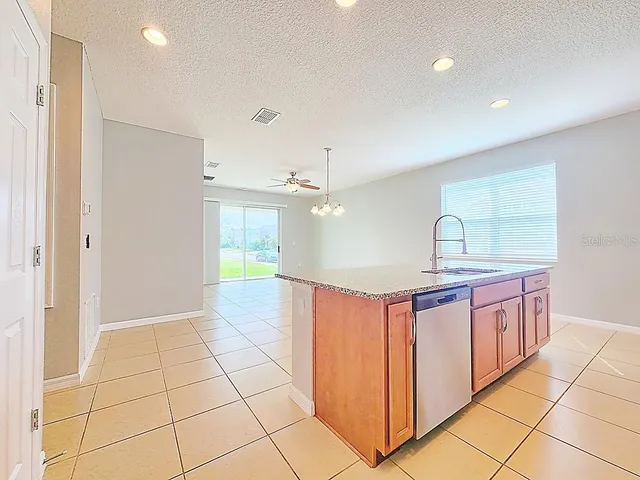 a kitchen with stainless steel appliances a sink stove and cabinets