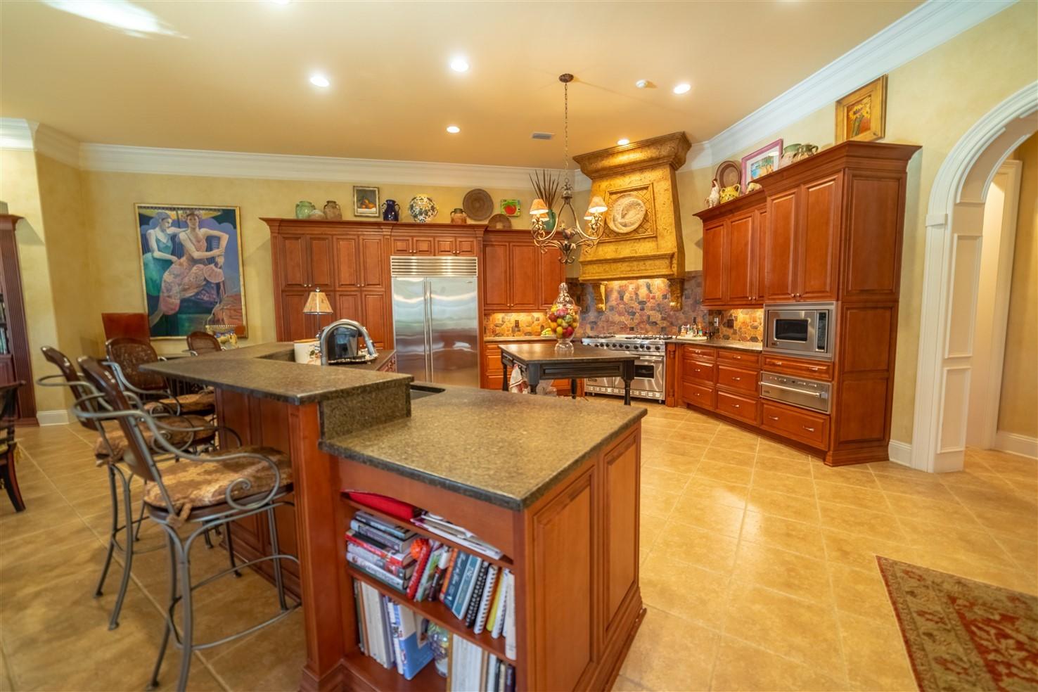 3594 Preserve Lane Miramar Beach, FL 32550 - Photo 12 of 35 a kitchen with stainless steel appliances granite countertop a sink a stove and a wooden cabinets