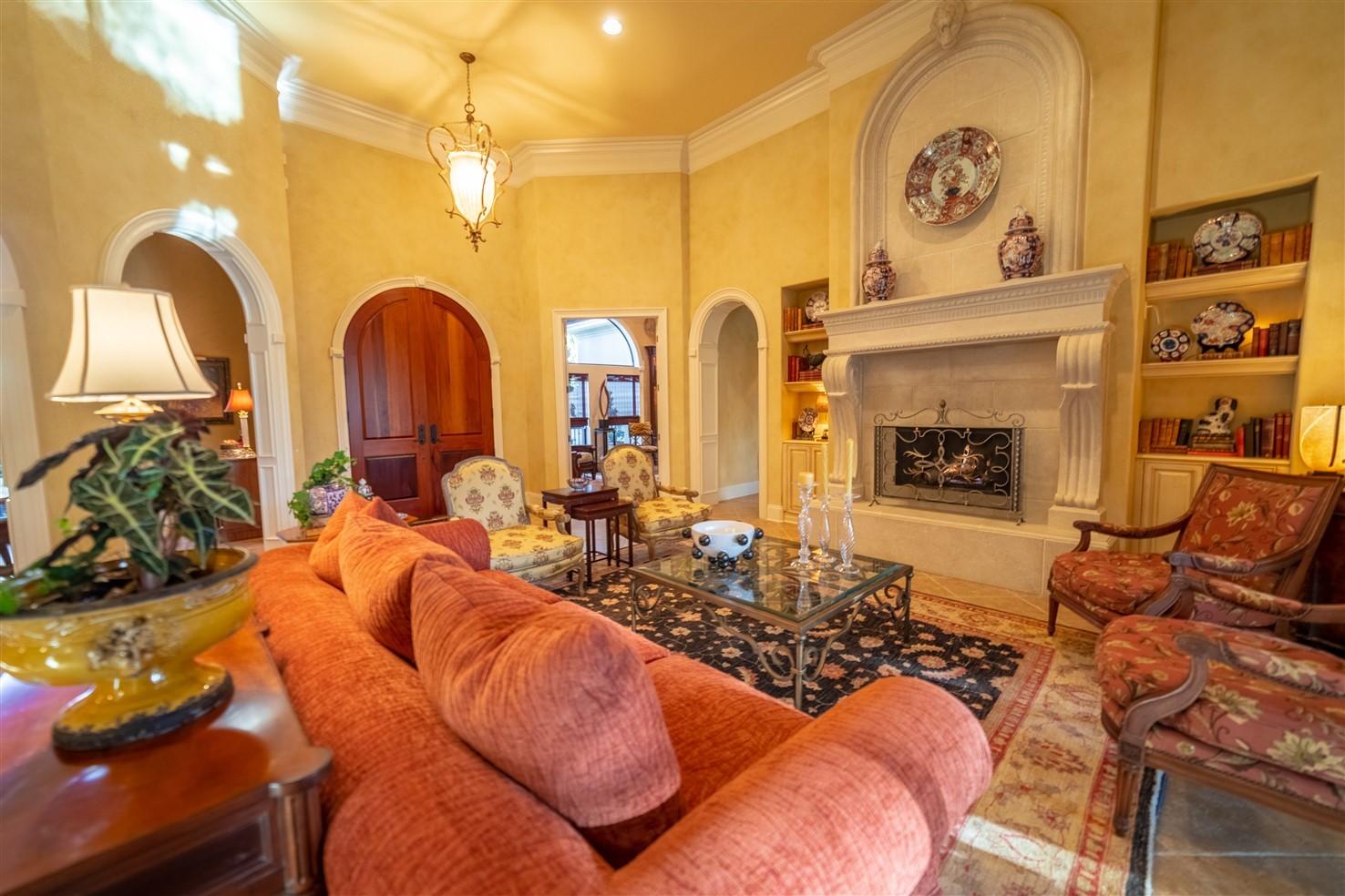 3594 Preserve Lane Miramar Beach, FL 32550 - Photo 7 of 35 a living room with furniture a fireplace and potted plants