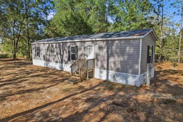 a view of a small yard with wooden fence