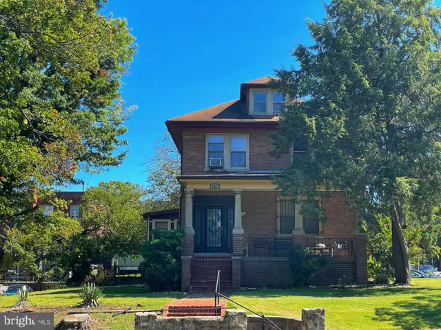 a view of a swimming pool with lawn chairs under an umbrella