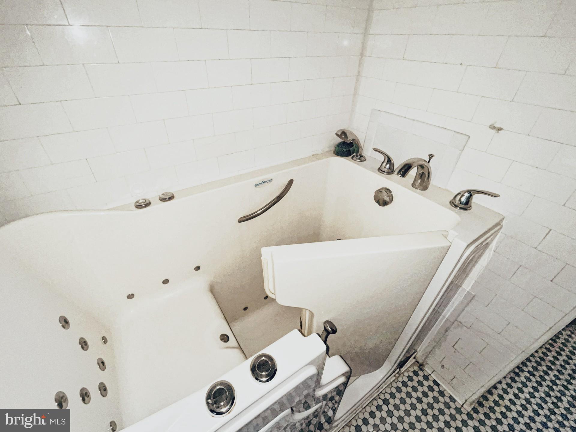 121 Raleigh Street Southeast Washington, DC 20032 - Photo 20 of 21 a bathroom with a bathtub and shower