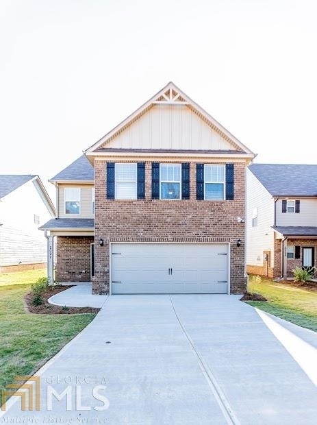 2459 Walker Drive, Unit 43 Hampton, GA 30228 - Photo 1 of 1 a front view of a house with a yard and garage