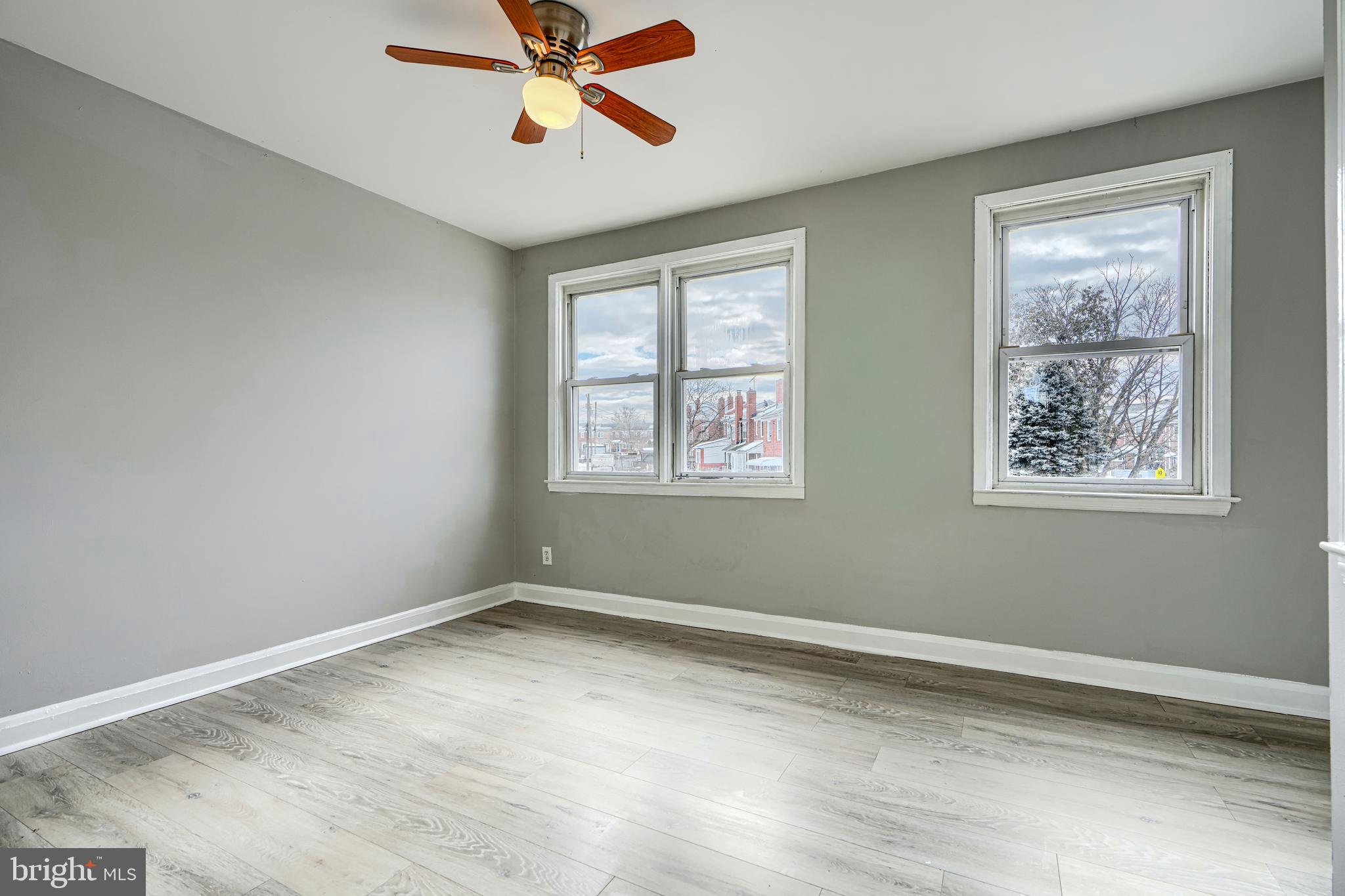 165 Hampshire Road Essex, MD 21221 - Photo 17 of 40 a view of a big room with wooden floor and windows