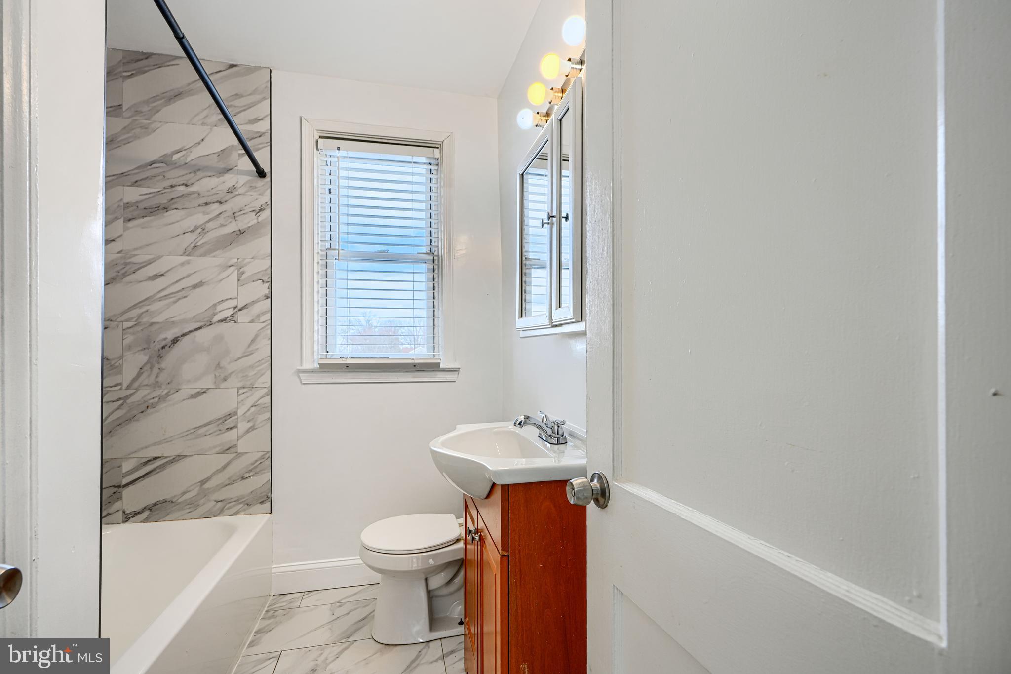 165 Hampshire Road Essex, MD 21221 - Photo 21 of 40 a bathroom with a sink a toilet and shower