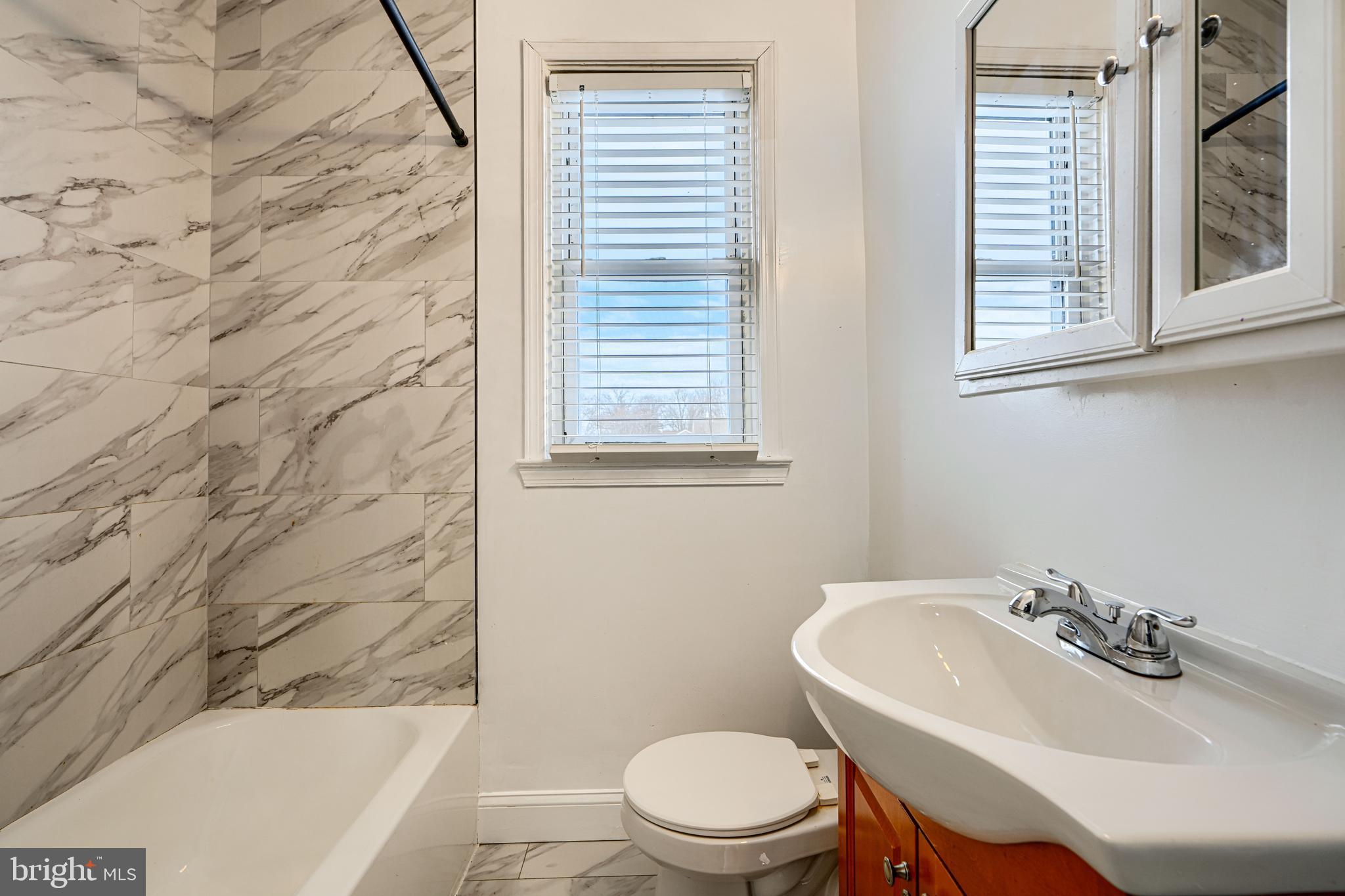 165 Hampshire Road Essex, MD 21221 - Photo 22 of 40 a bathroom with a sink a toilet and shower