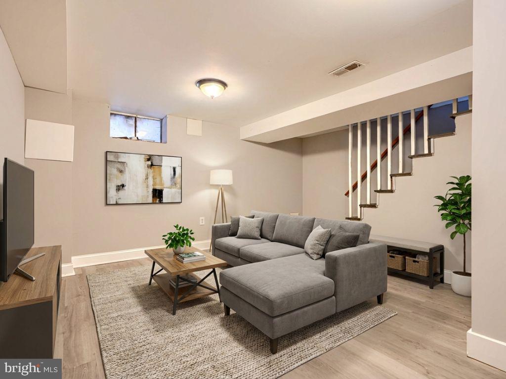 165 Hampshire Road Essex, MD 21221 - Photo 26 of 40 a living room with furniture a wooden floor and a flat screen tv