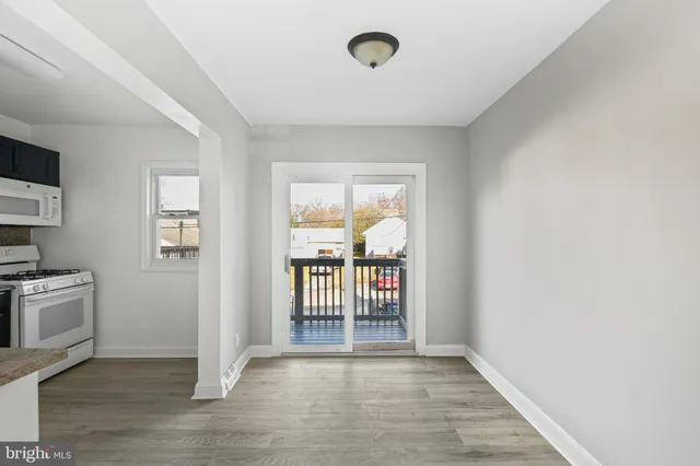 an empty room with cabinet and a refrigerator
