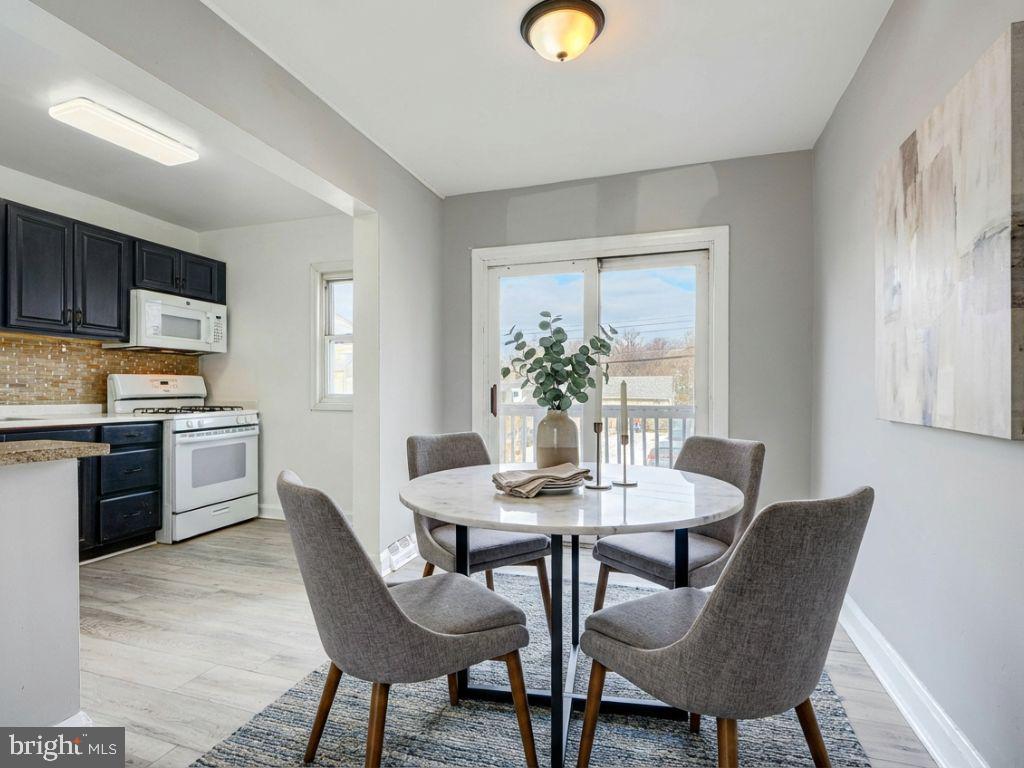 165 Hampshire Road Essex, MD 21221 - Photo 8 of 40 a view of a dining room with furniture and wooden floor