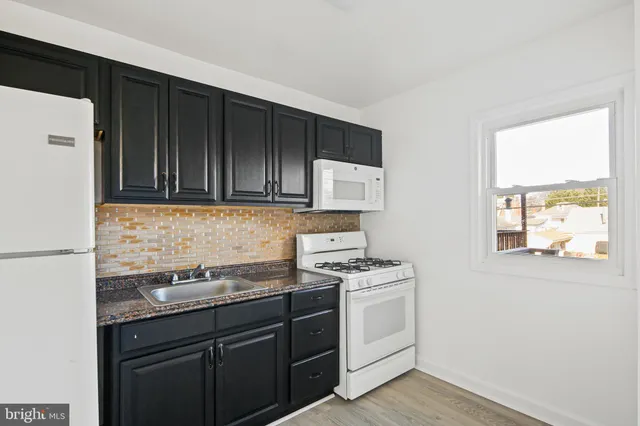 a view of an empty room and wooden floor