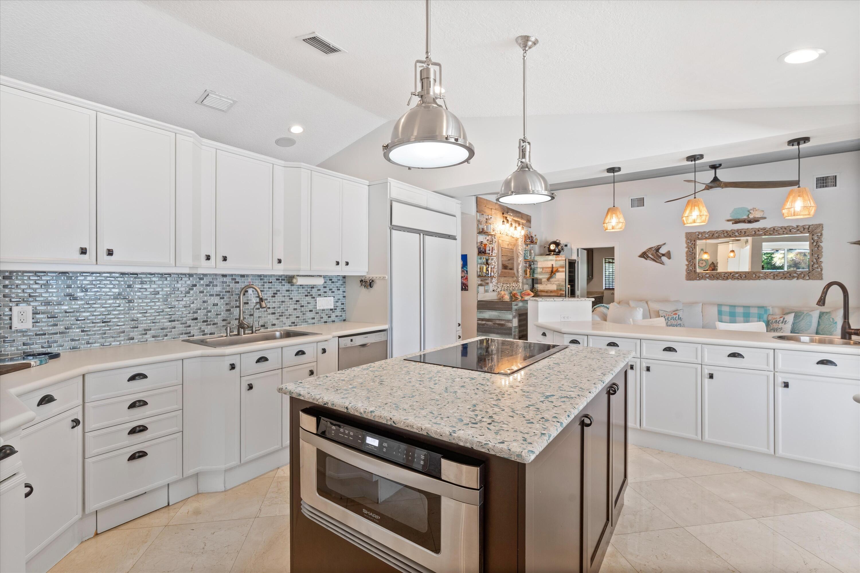 830 Northeast Boca Bay Colony Drive Boca Raton, FL 33487 - Photo 18 of 52 a kitchen with granite countertop a sink a counter space appliances and cabinets