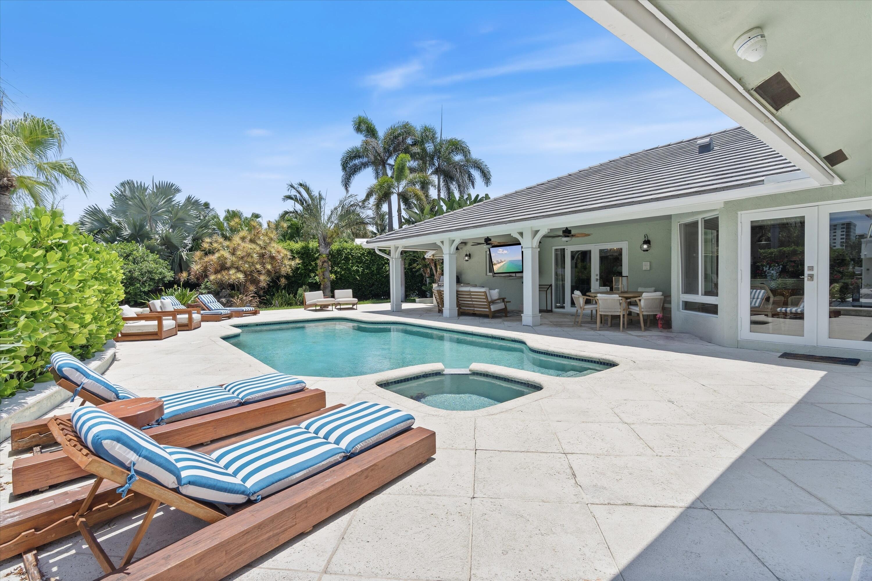 830 Northeast Boca Bay Colony Drive Boca Raton, FL 33487 - Photo 40 of 52 a view of swimming pool with chairs and tables