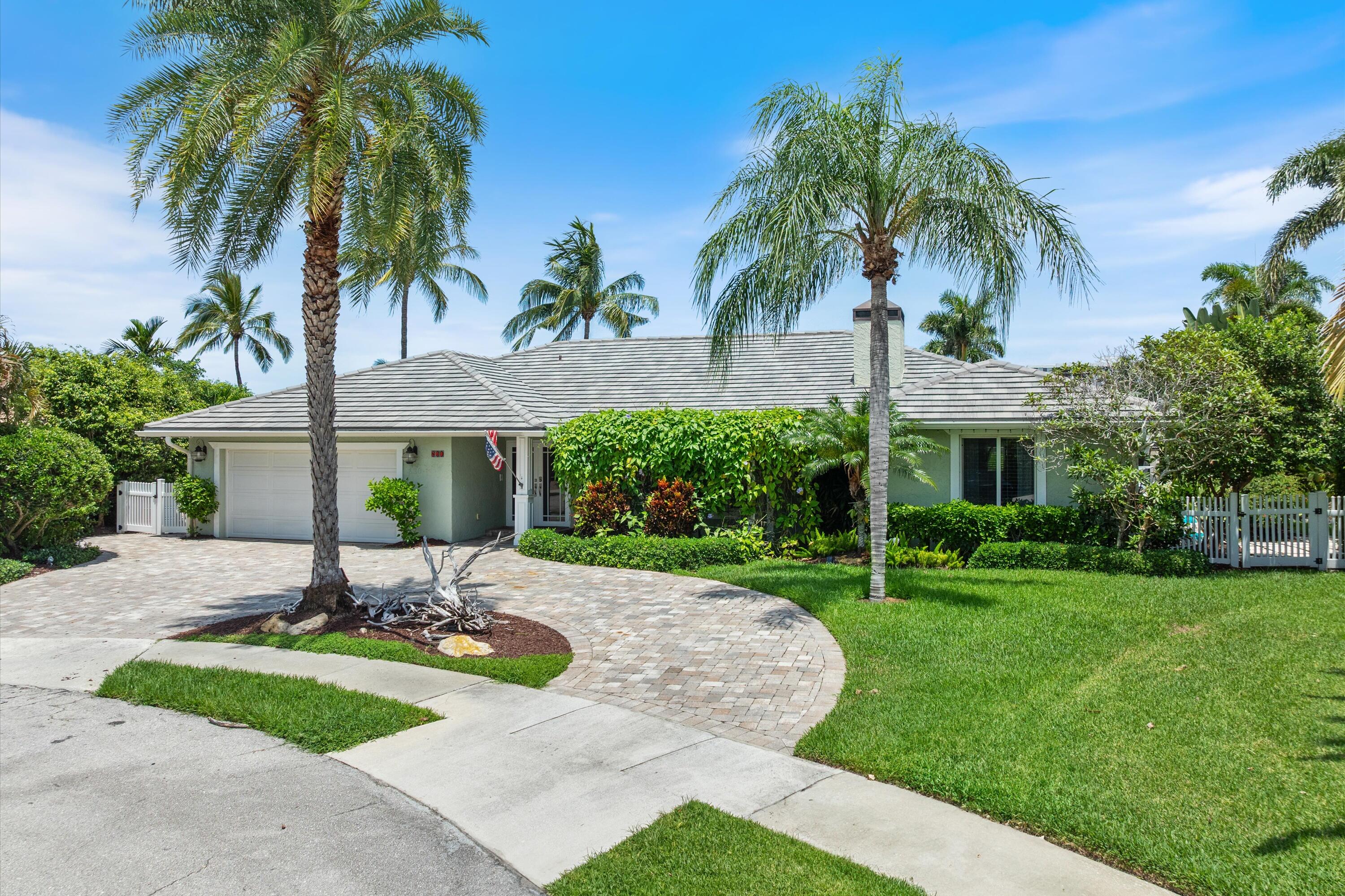 830 Northeast Boca Bay Colony Drive Boca Raton, FL 33487 - Photo 9 of 52 a view of a backyard with a garden and palm trees