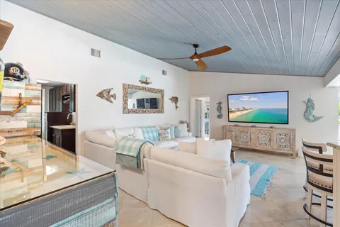 a living room with furniture and view of kitchen