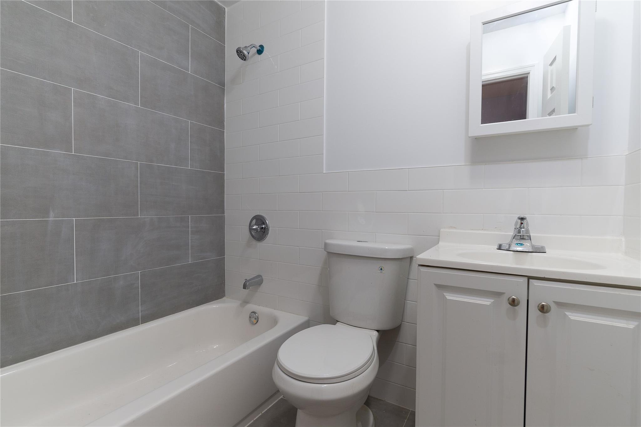 1102 Jackson Avenue Bronx, NY 10456 - Photo 11 of 36 a bathroom with a toilet a sink and bathtub