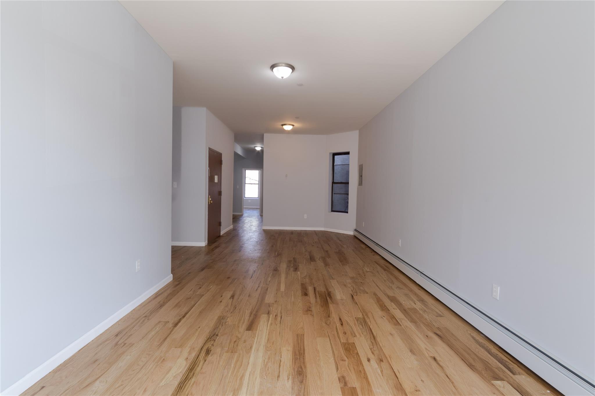 1102 Jackson Avenue Bronx, NY 10456 - Photo 13 of 36 a view of hallway with wooden floor
