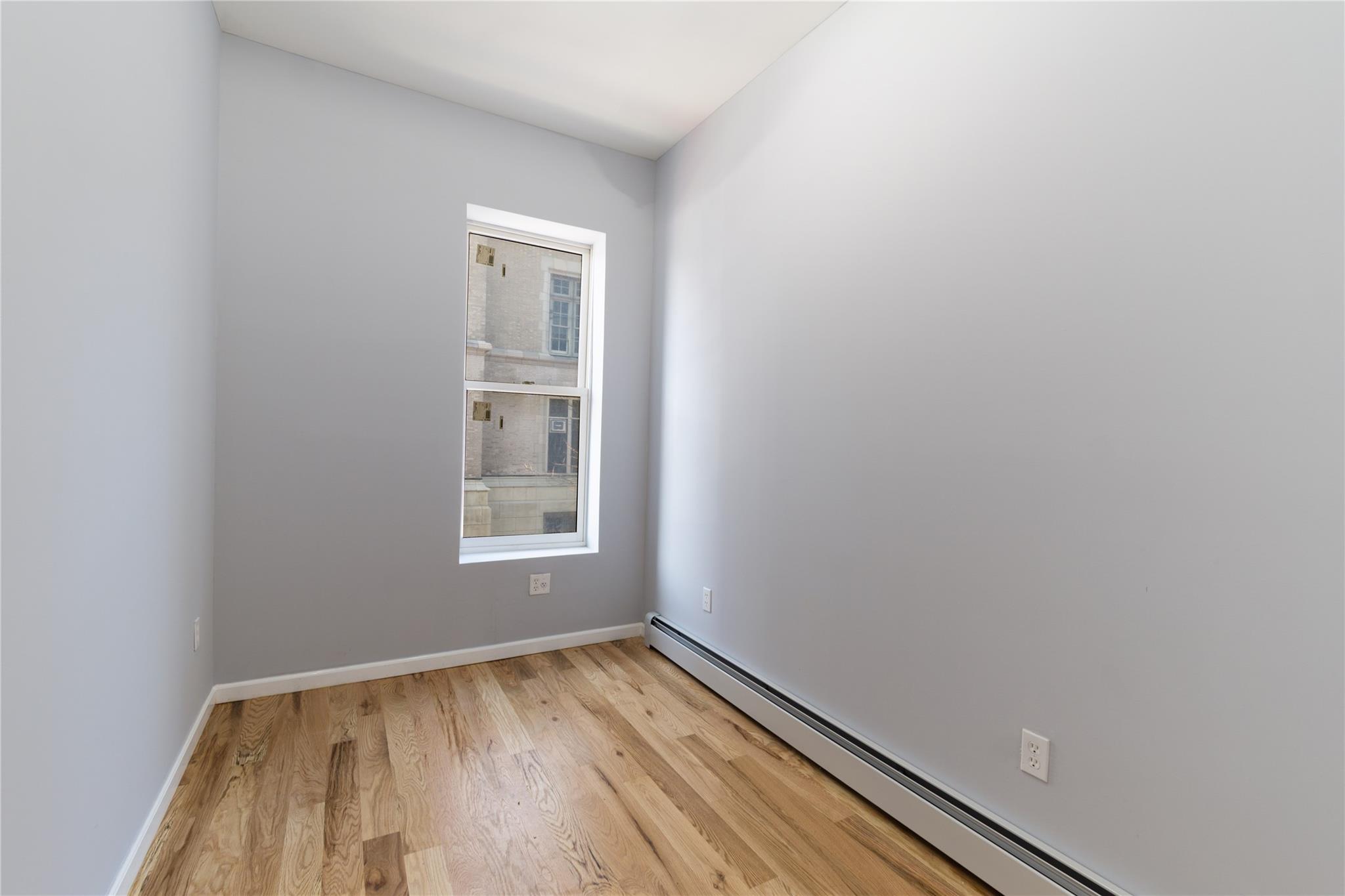 1102 Jackson Avenue Bronx, NY 10456 - Photo 15 of 36 a view of an empty room and window