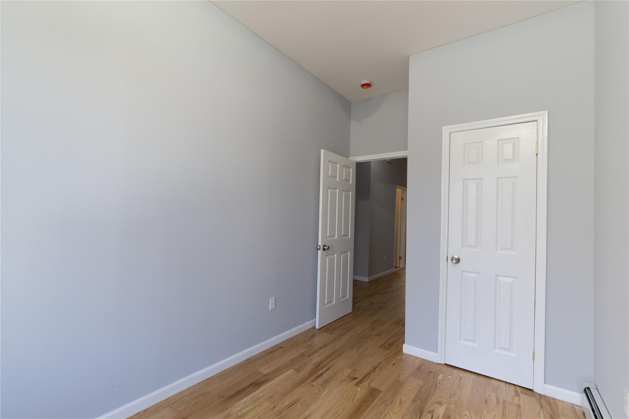 1102 Jackson Avenue Bronx, NY 10456 - Photo 18 of 36 a view of hallway with wooden floor