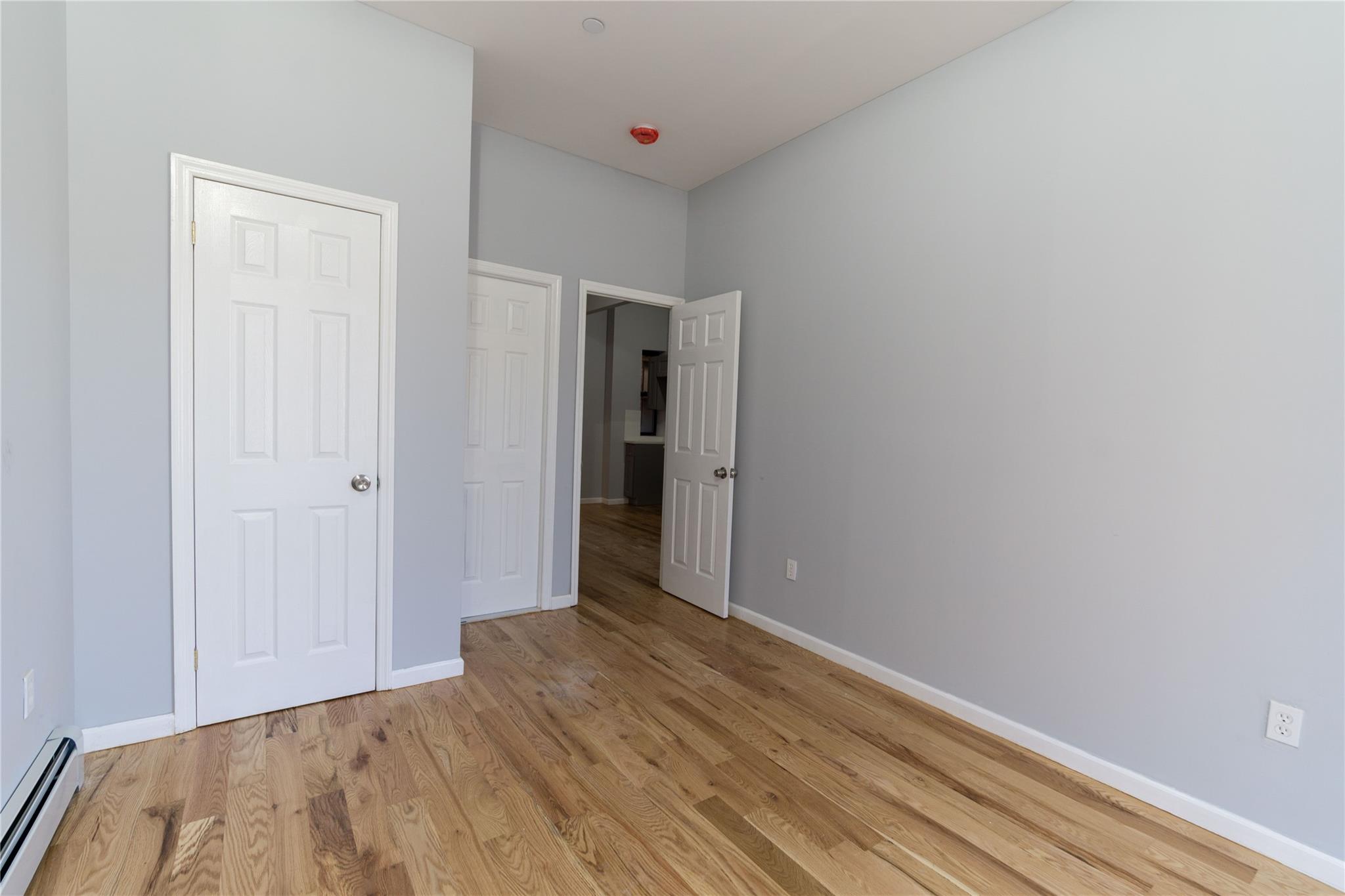 1102 Jackson Avenue Bronx, NY 10456 - Photo 20 of 36 a view of a room with wooden floor