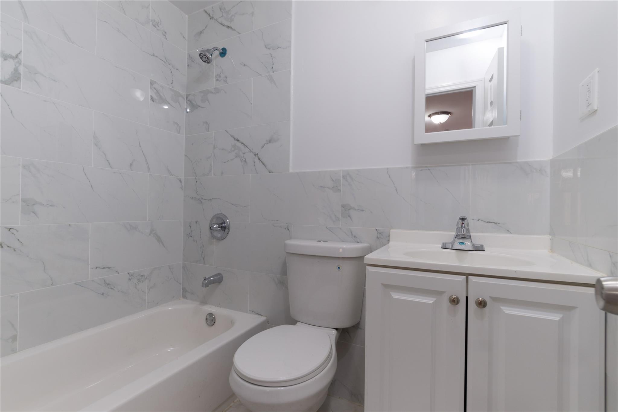 1102 Jackson Avenue Bronx, NY 10456 - Photo 22 of 36 a bathroom with a sink a toilet and bathtub