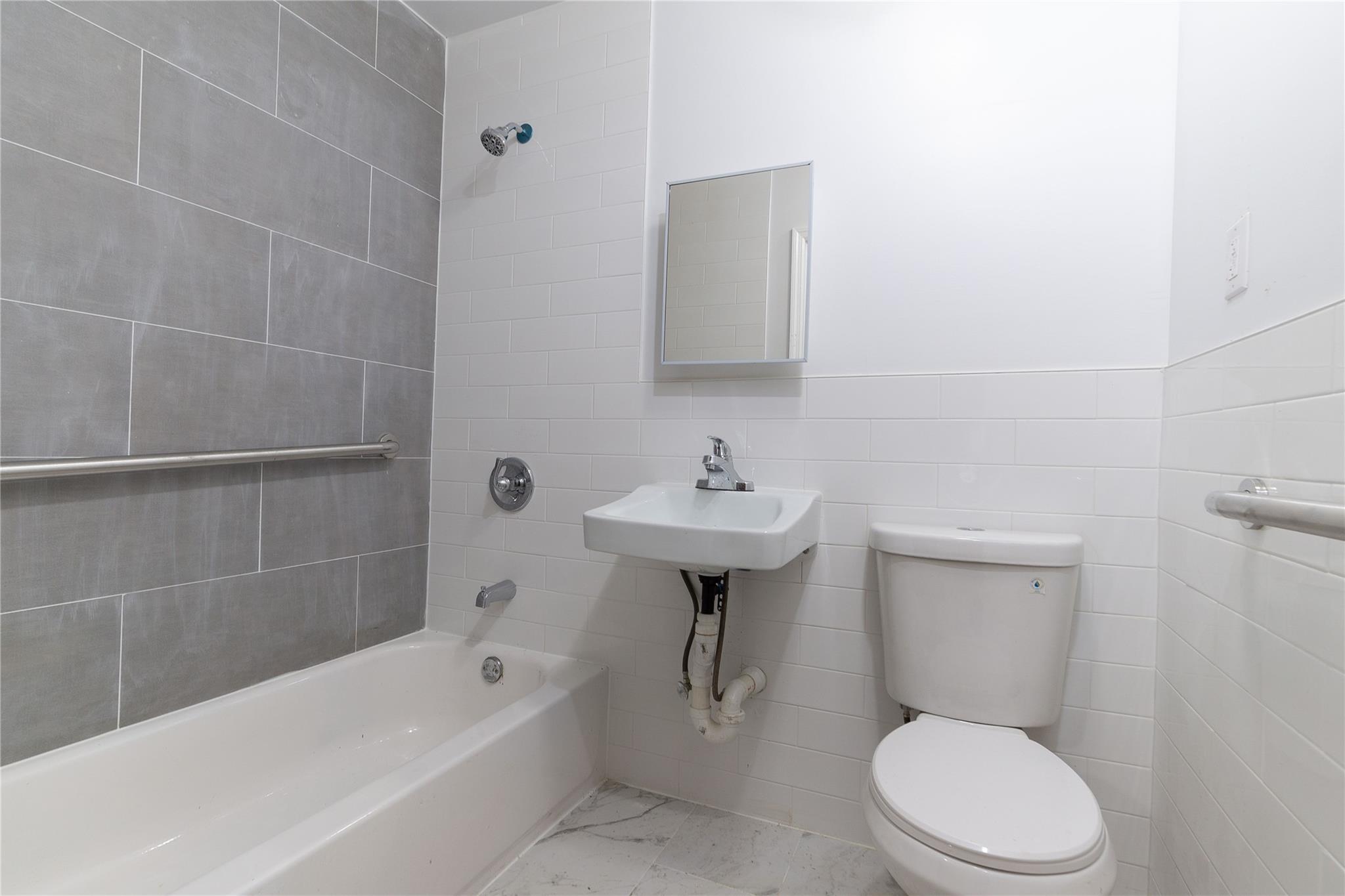 1102 Jackson Avenue Bronx, NY 10456 - Photo 23 of 36 a white toilet sitting next to a bathroom sink