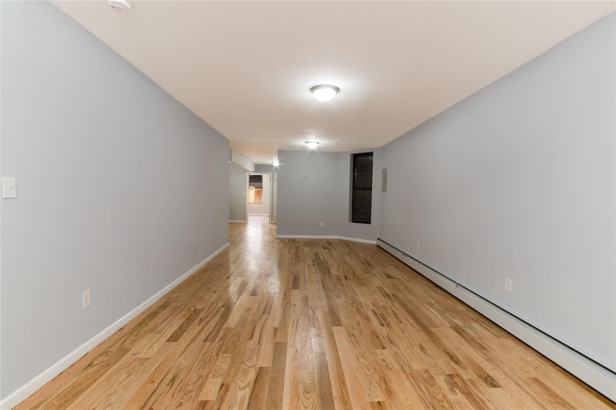 1102 Jackson Avenue Bronx, NY 10456 - Photo 25 of 36 a view of hallway with wooden floor