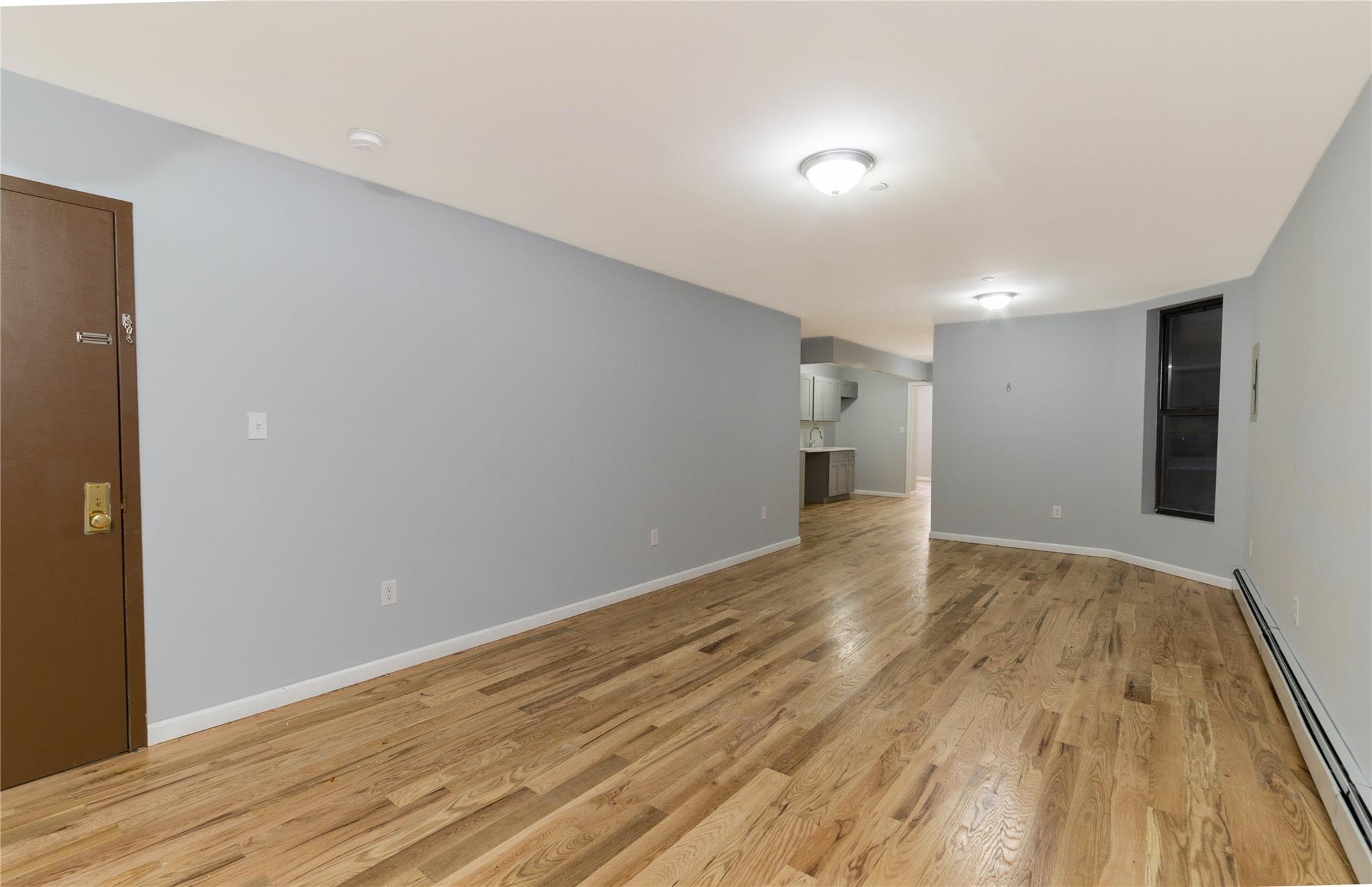 1102 Jackson Avenue Bronx, NY 10456 - Photo 26 of 36 a view of an empty room with wooden floor