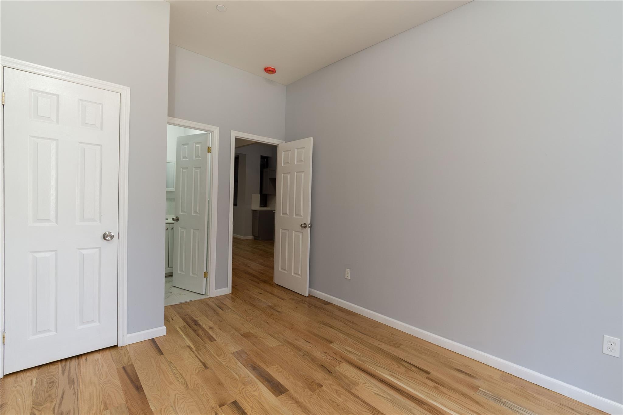 1102 Jackson Avenue Bronx, NY 10456 - Photo 6 of 36 a view of a room with wooden floor and closet