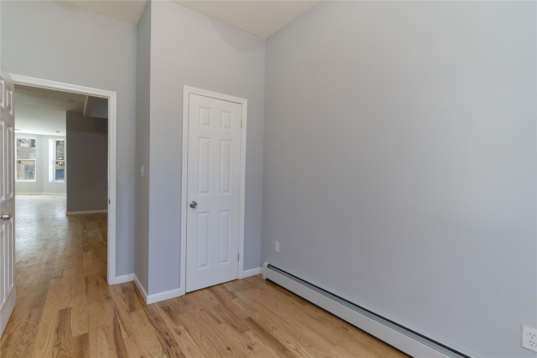 1102 Jackson Avenue Bronx, NY 10456 - Photo 8 of 36 a view of hallway with wooden floor