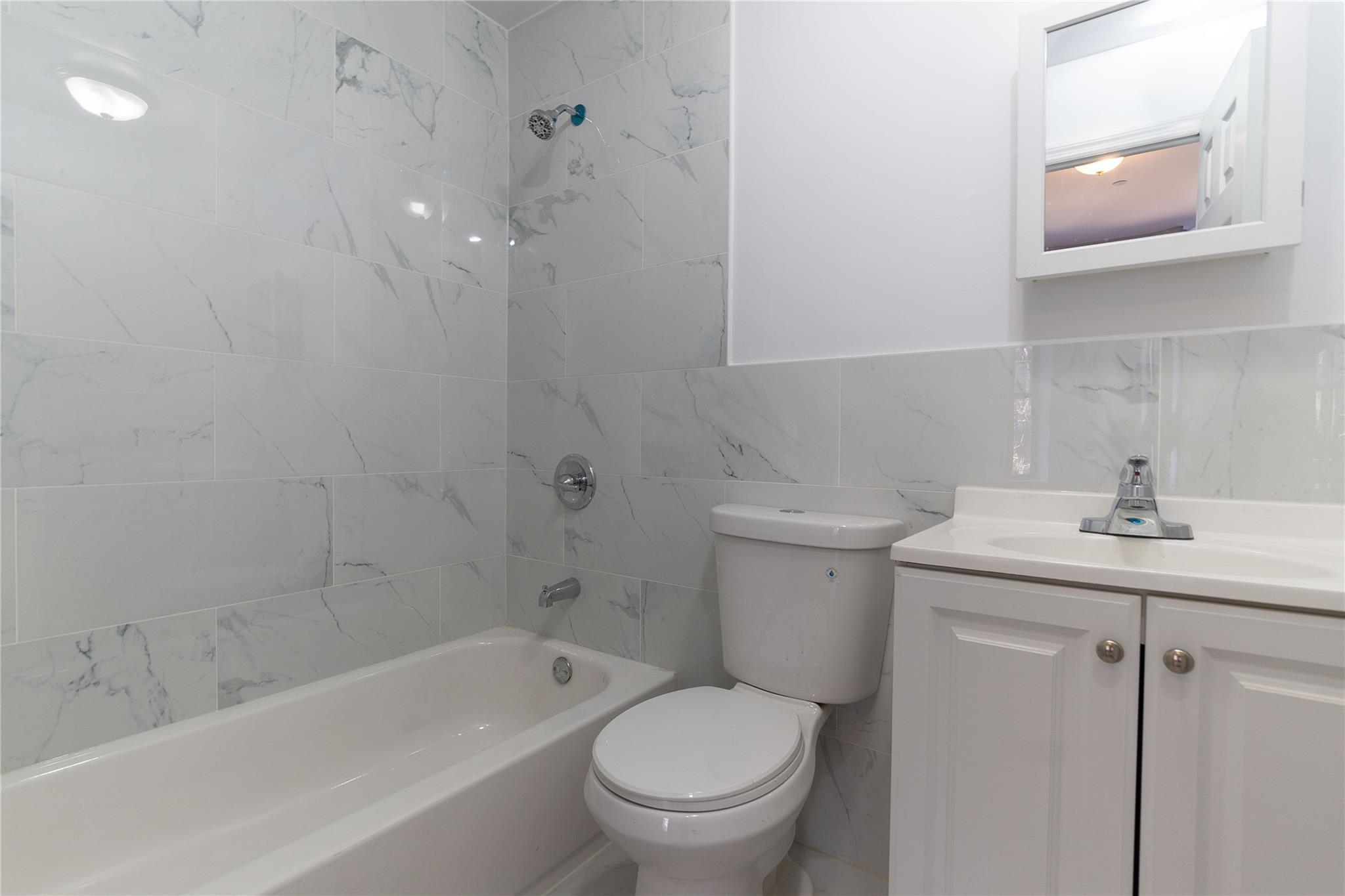 1102 Jackson Avenue Bronx, NY 10456 - Photo 10 of 36 a bathroom with a sink toilet and bathtub