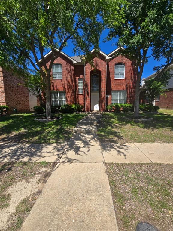 4325 Ridge Point Lane Plano, TX 75024 - Photo 3 of 11 View of front facade with a front lawn and brick siding
