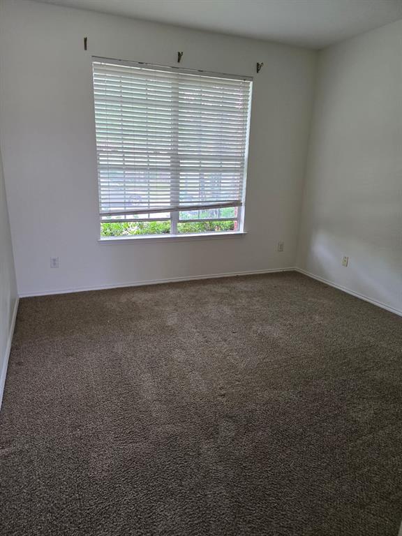4325 Ridge Point Lane Plano, TX 75024 - Photo 5 of 11 Unfurnished room featuring carpet flooring and baseboards