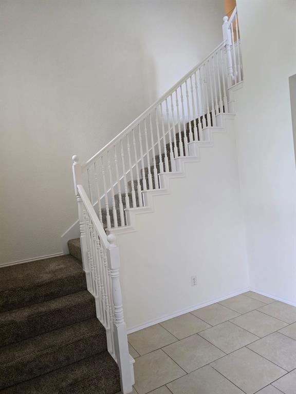 4325 Ridge Point Lane Plano, TX 75024 - Photo 10 of 11 Stairway with tile patterned flooring and baseboards