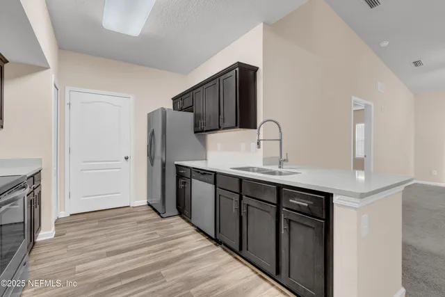 a kitchen with a sink and refrigerator