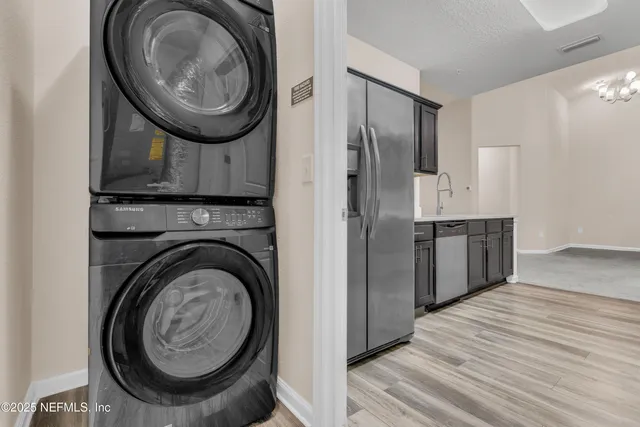 a view of a hallway with washer and dryer