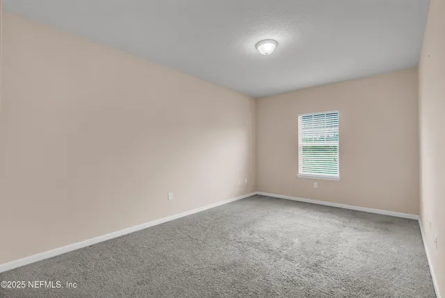 an empty room with a empty space and windows