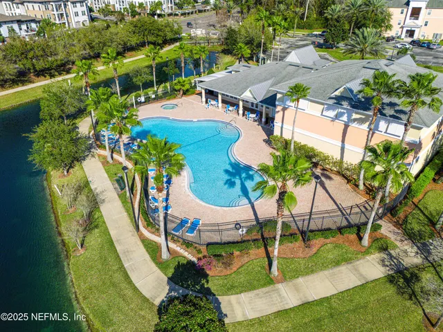 a view of a house with pool and chairs