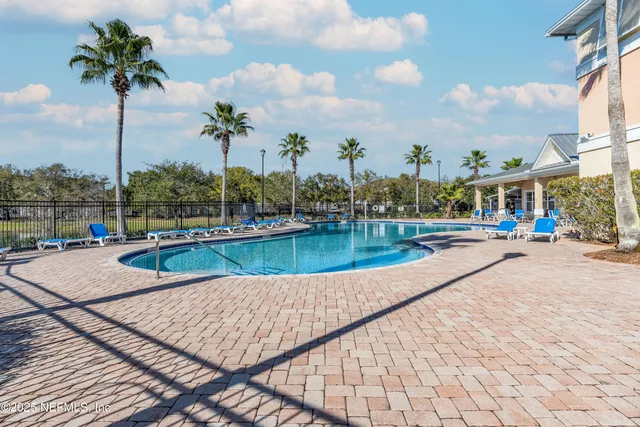 a view of a patio with a table and chairs and potted plants