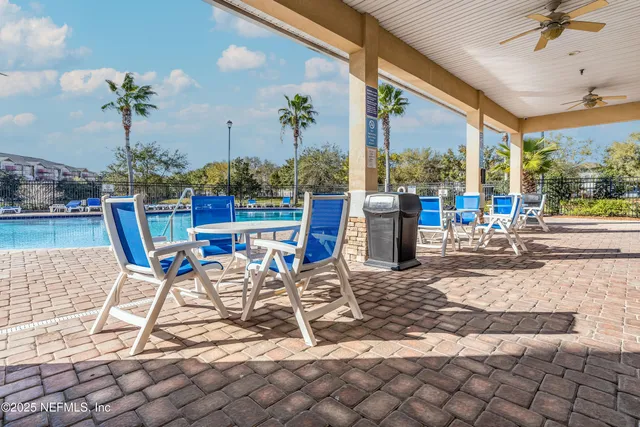 a room with furniture pool table and windows