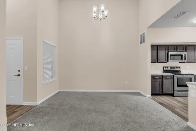 a kitchen with a refrigerator and a stove top oven