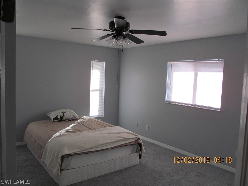 17532 Butler Road Fort Myers, FL 33967 - Photo 11 of 29 a bedroom with a bed and a window