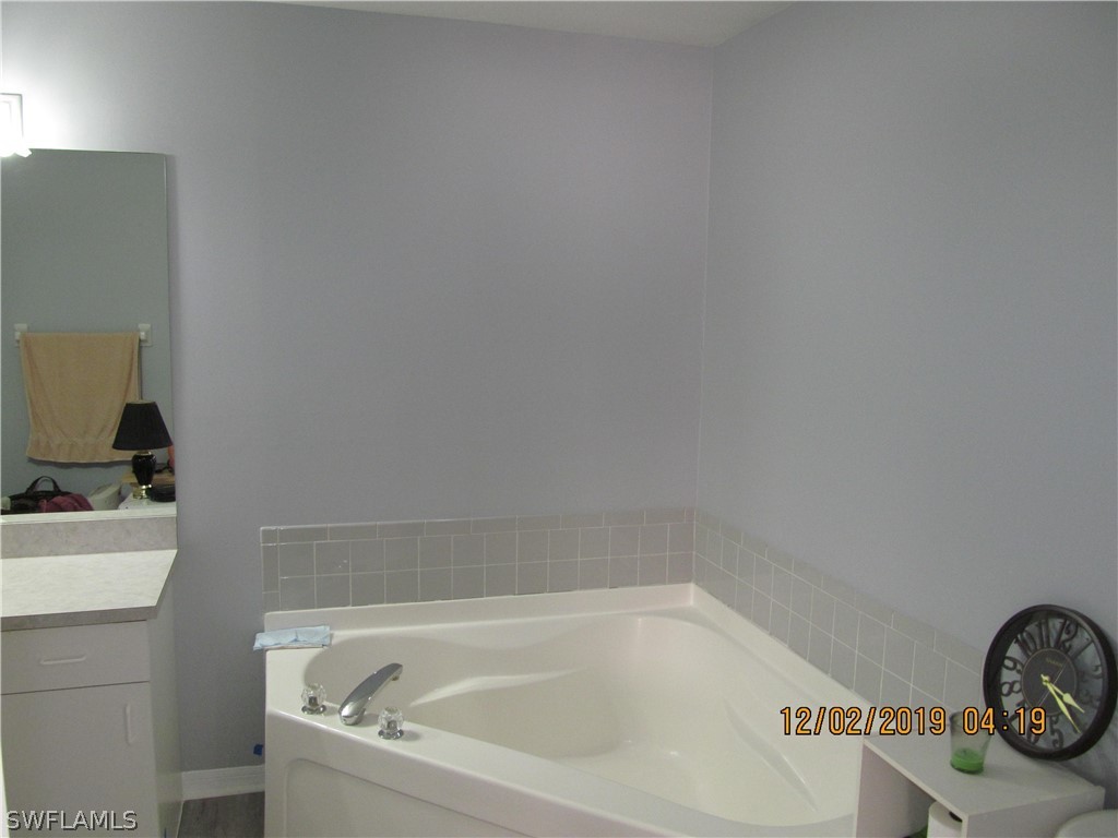 17532 Butler Road Fort Myers, FL 33967 - Photo 13 of 29 a bathroom with a bathtub