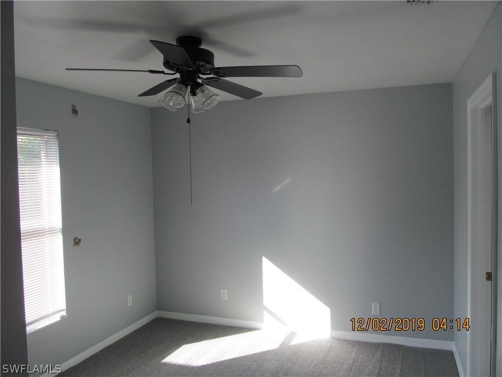17532 Butler Road Fort Myers, FL 33967 - Photo 21 of 29 a room with a window and a ceiling fan