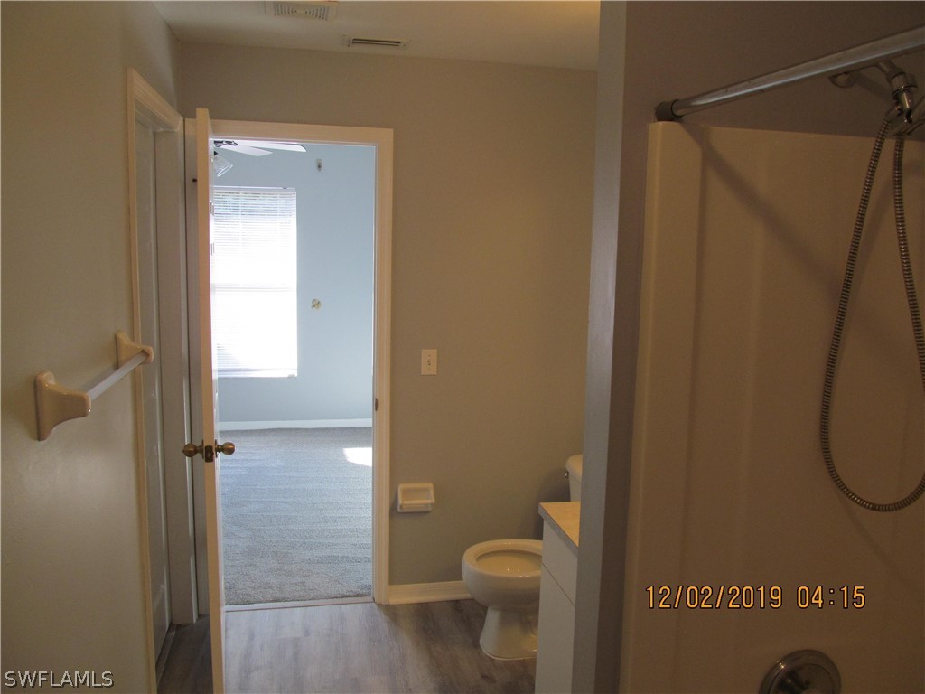 17532 Butler Road Fort Myers, FL 33967 - Photo 23 of 29 a bathroom with a granite countertop shower and a toilet