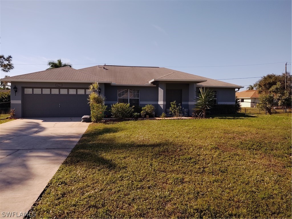 17532 Butler Road Fort Myers, FL 33967 - Photo 28 of 29 a front view of a house with a yard